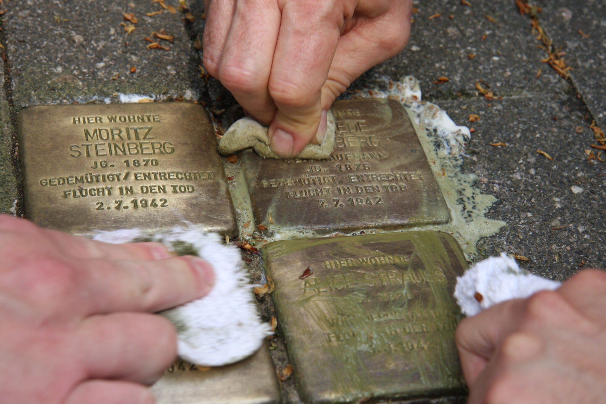 Photograph of stumbling stones being cleaned.