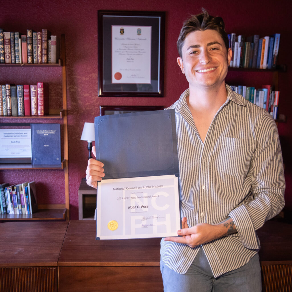 Photograph of Noah Price holding his New Professional Award