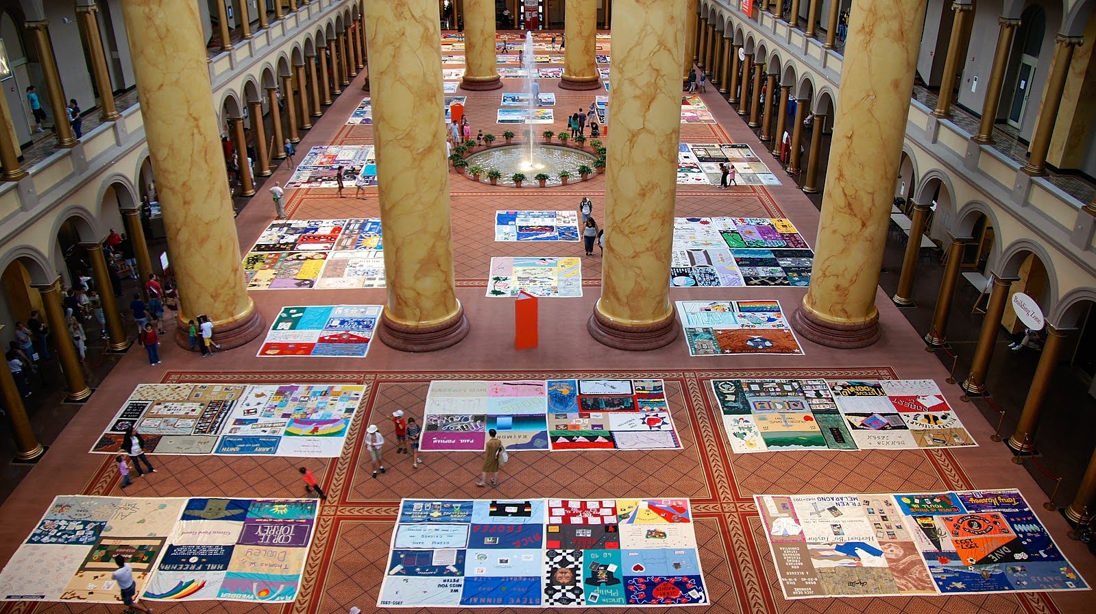 People viewing the AIDS Memorial Quilt on display at the National Building Museum in Washington, D.C. Image Credit: Wikimedia Commons
